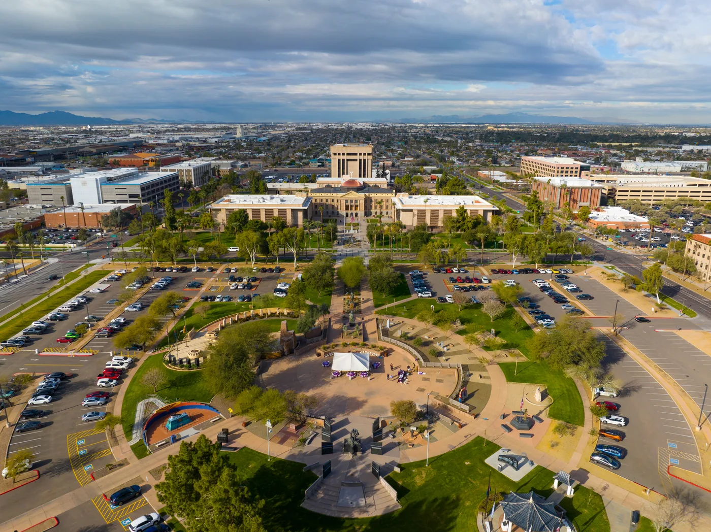 An aerial view over a built-up area with landscaped open ground running between the blocks